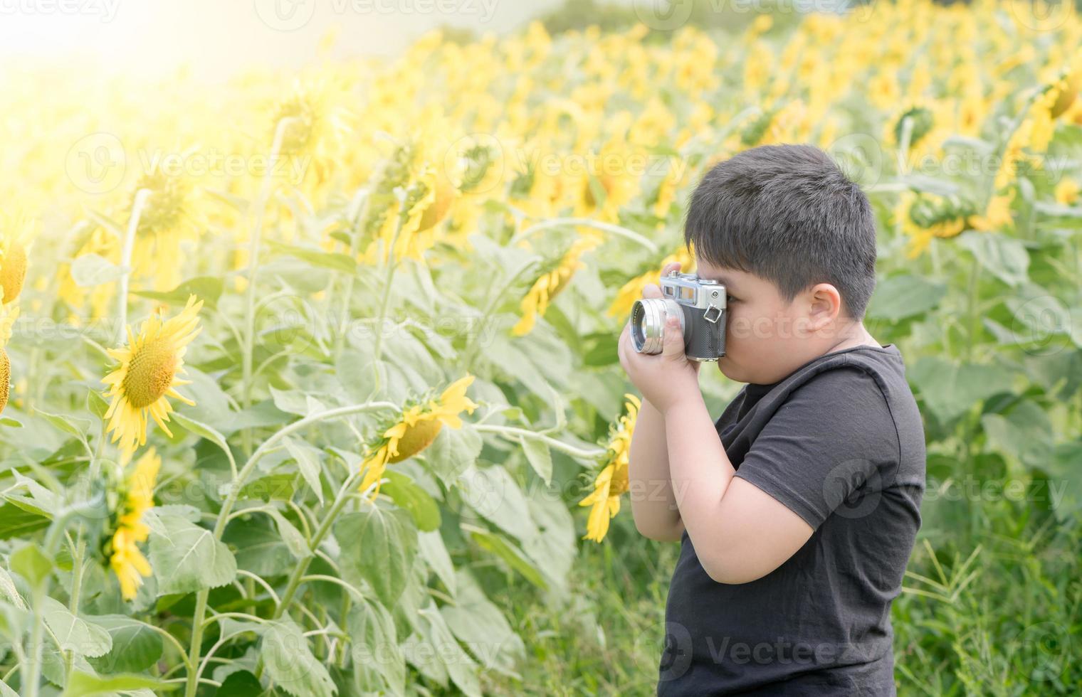 Child Holding old camera to Take Photos sunflower flower
