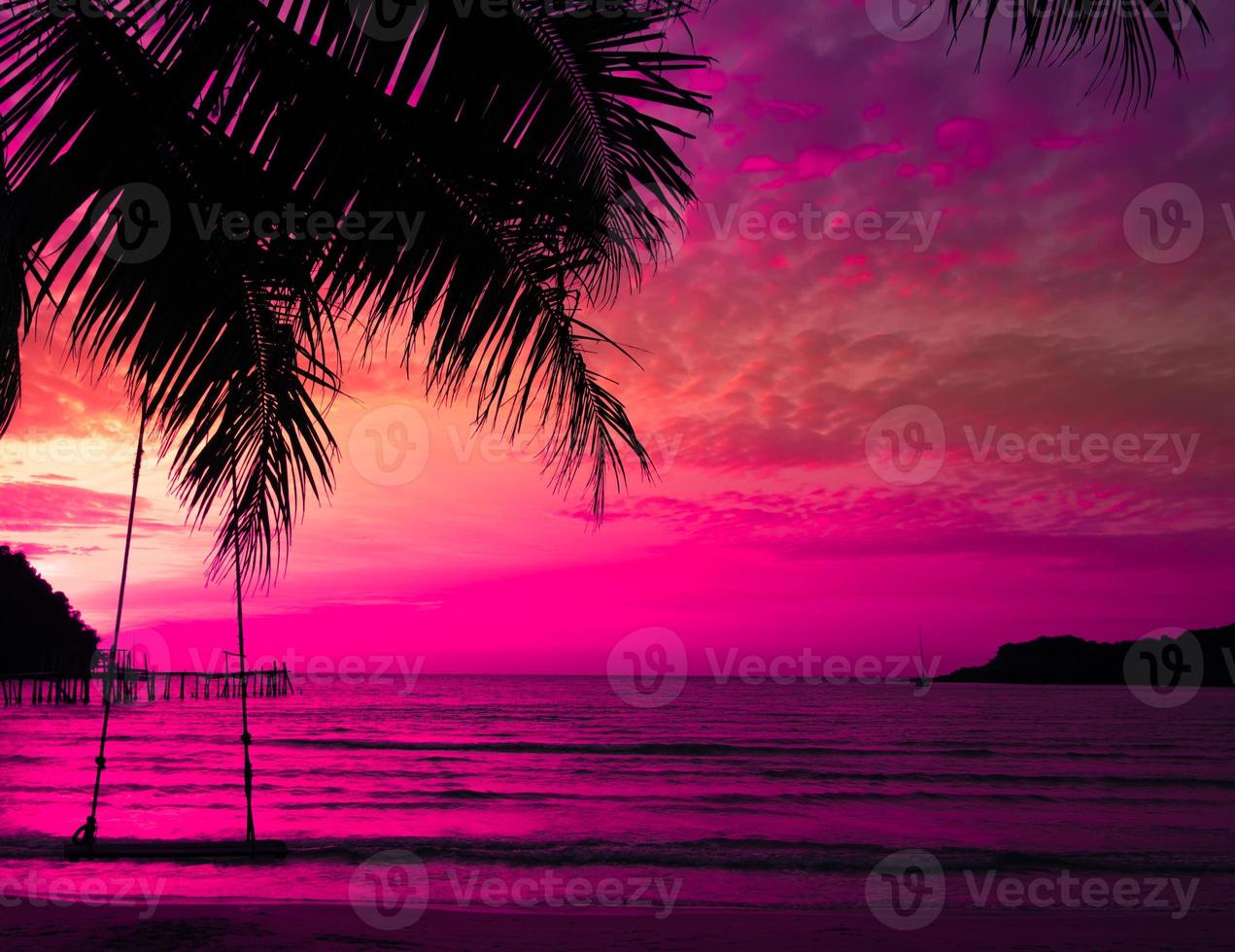 palm tree on sunset of beautiful a tropical beach on pink sky background as summer photo
