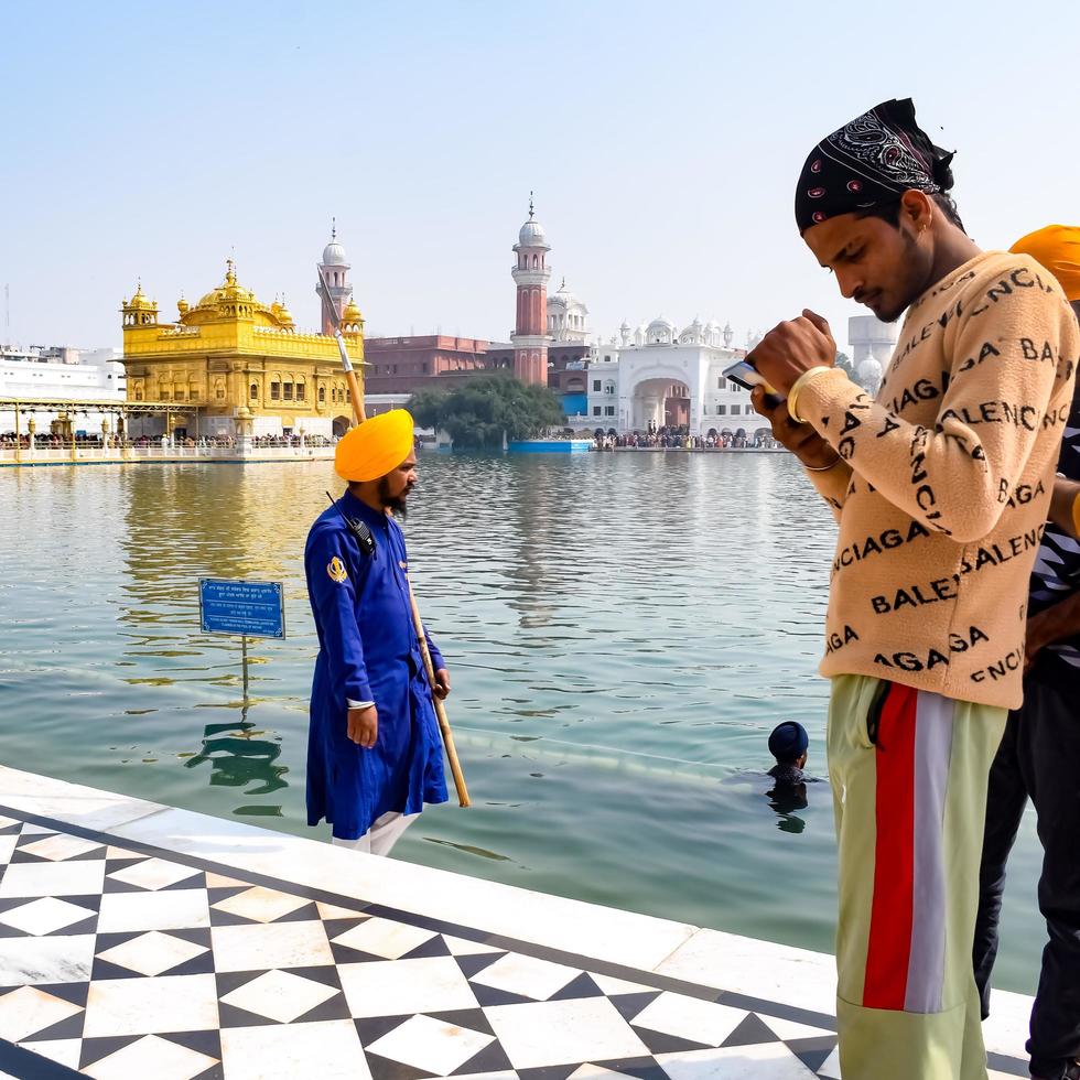 Amritsar, India - February 26 2023 - Unidentified devotees from various parts at Golden Temple - Harmandir Sahib in Amritsar, Punjab, India, Famous indian sikh landmark, Golden Temple photo