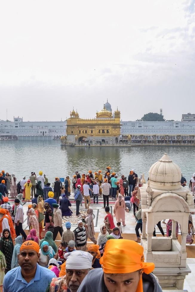 Amritsar, India - February 26 2023 - Unidentified devotees from various parts at Golden Temple Harmandir Sahib in Amritsar, Punjab, India, Famous indian sikh landmark, Golden Temple photo