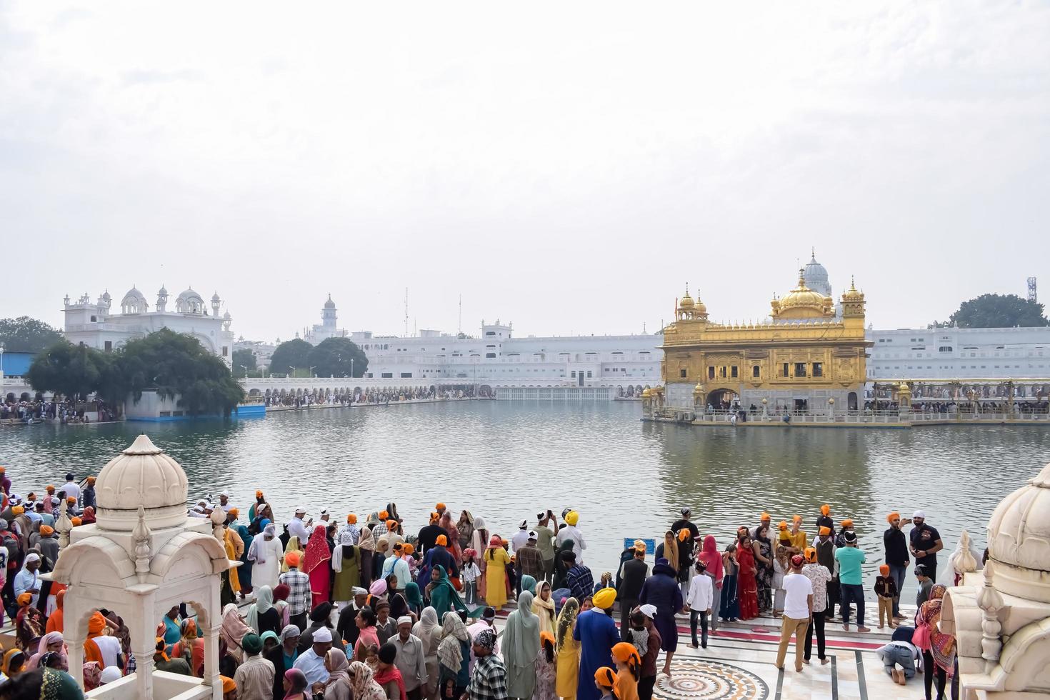 Amritsar, India - February 26 2023 - Unidentified devotees from various parts at Golden Temple Harmandir Sahib in Amritsar, Punjab, India, Famous indian sikh landmark, Golden Temple photo