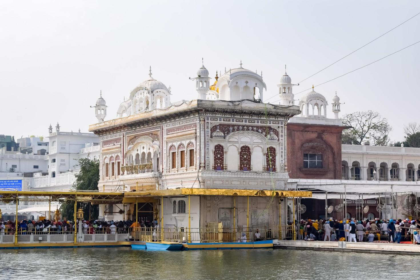 Amritsar, India - February 26 2023 - Unidentified devotees from various parts at Golden Temple Harmandir Sahib in Amritsar, Punjab, India, Famous indian sikh landmark, Golden Temple photo