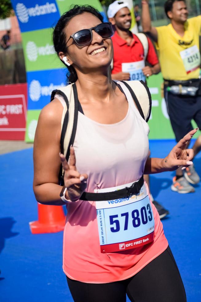 New Delhi, India - October 16 2022 - Vedanta Delhi Half Marathon race after covid in which marathon participants about to cross the finish line, Delhi Half Marathon 2022 photo