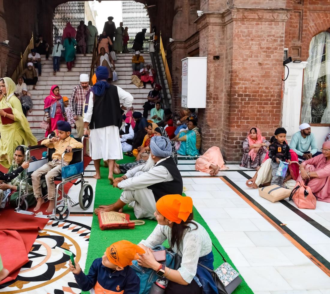 Amritsar, India - February 26 2023 - Unidentified devotees from various parts at Golden Temple - Harmandir Sahib in Amritsar, Punjab, India, Famous indian sikh landmark, Golden Temple photo
