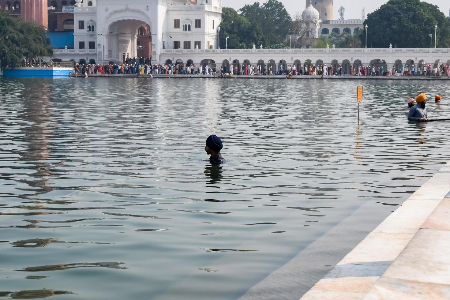 Amritsar, India - February 26 2023 - Unidentified devotees from various parts at Golden Temple - Harmandir Sahib in Amritsar, Punjab, India, Famous indian sikh landmark, Golden Temple photo