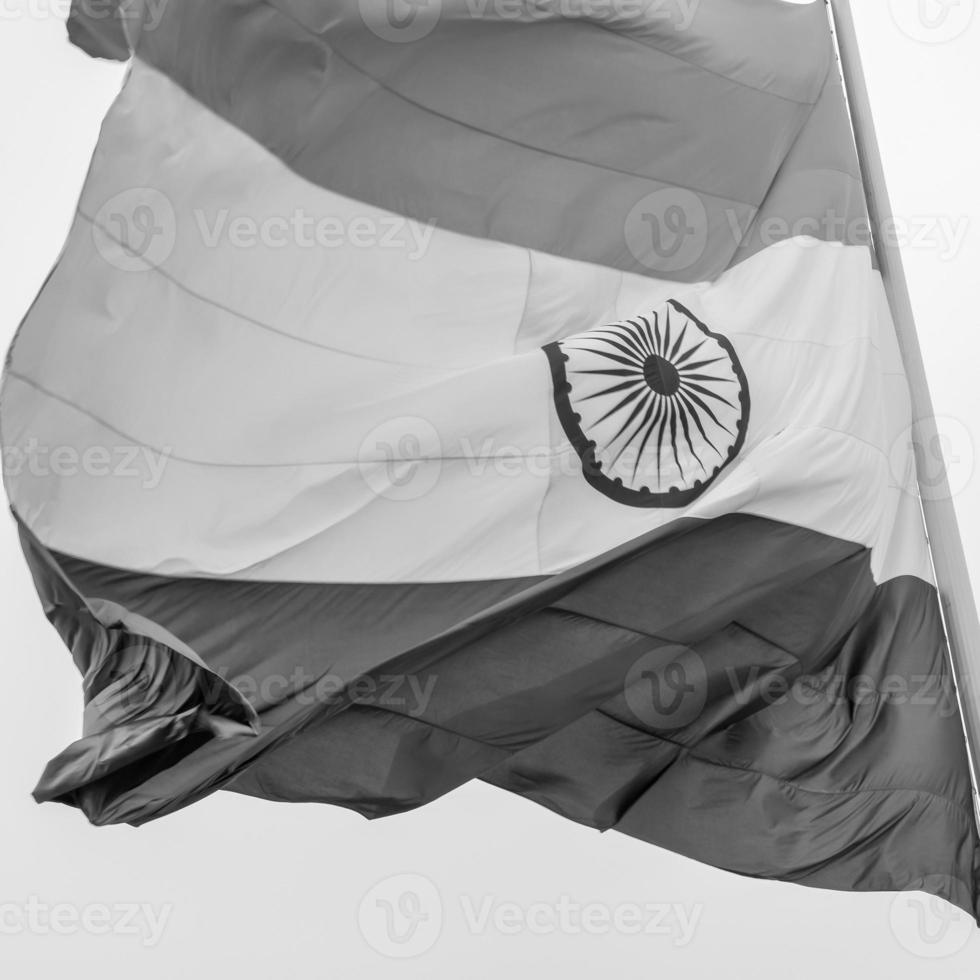 India flag flying high at Connaught Place with pride in blue sky, India flag fluttering, Indian Flag on Independence Day and Republic Day of India, tilt up shot, Waving Indian flag, Har Ghar Tiranga photo