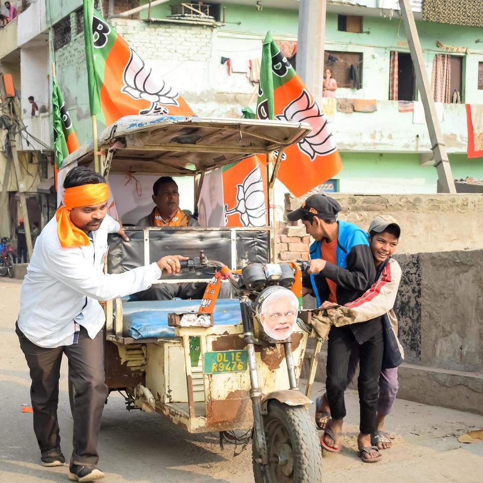 Delhi, India, December 02 2022 -Bharatiya Janata Party - BJP supporter during mega road show in support of BJP candidate Pankaj Luthara to file nomination papers ahead of MCD local body Elections 2022 photo