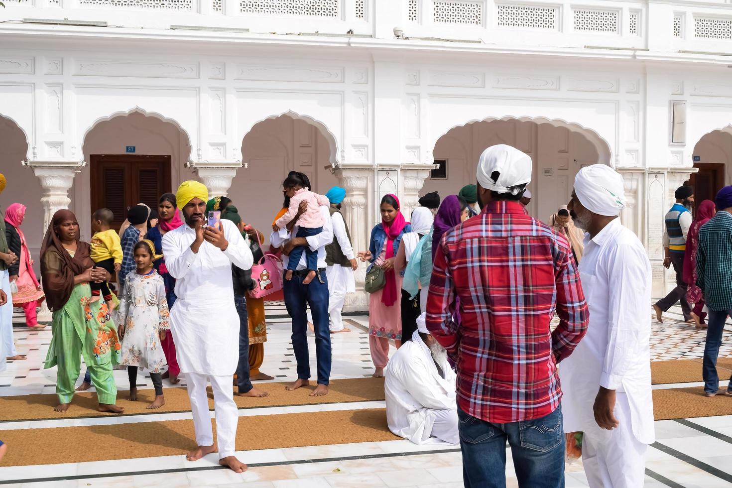 Amritsar, India - February 26 2023 - Unidentified devotees from various parts at Golden Temple - Harmandir Sahib in Amritsar, Punjab, India, Famous indian sikh landmark, Golden Temple photo