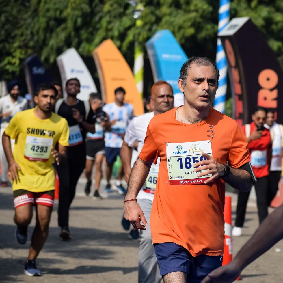 New Delhi, India - October 16 2022 - Vedanta Delhi Half Marathon race after covid in which marathon participants about to cross the finish line, Delhi Half Marathon 2022 photo