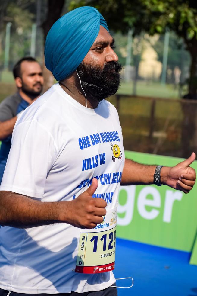 New Delhi, India - October 16 2022 - Vedanta Delhi Half Marathon race after covid in which marathon participants about to cross the finish line, Delhi Half Marathon 2022 photo
