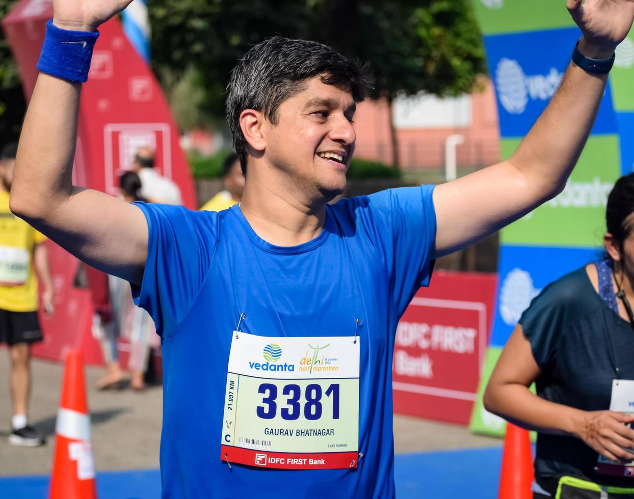 New Delhi, India - October 16 2022 - Vedanta Delhi Half Marathon race after covid in which marathon participants about to cross the finish line, Delhi Half Marathon 2022 photo