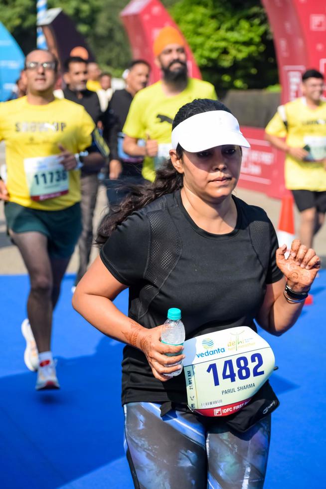 New Delhi, India - October 16 2022 - Vedanta Delhi Half Marathon race after covid in which marathon participants about to cross the finish line, Delhi Half Marathon 2022 photo