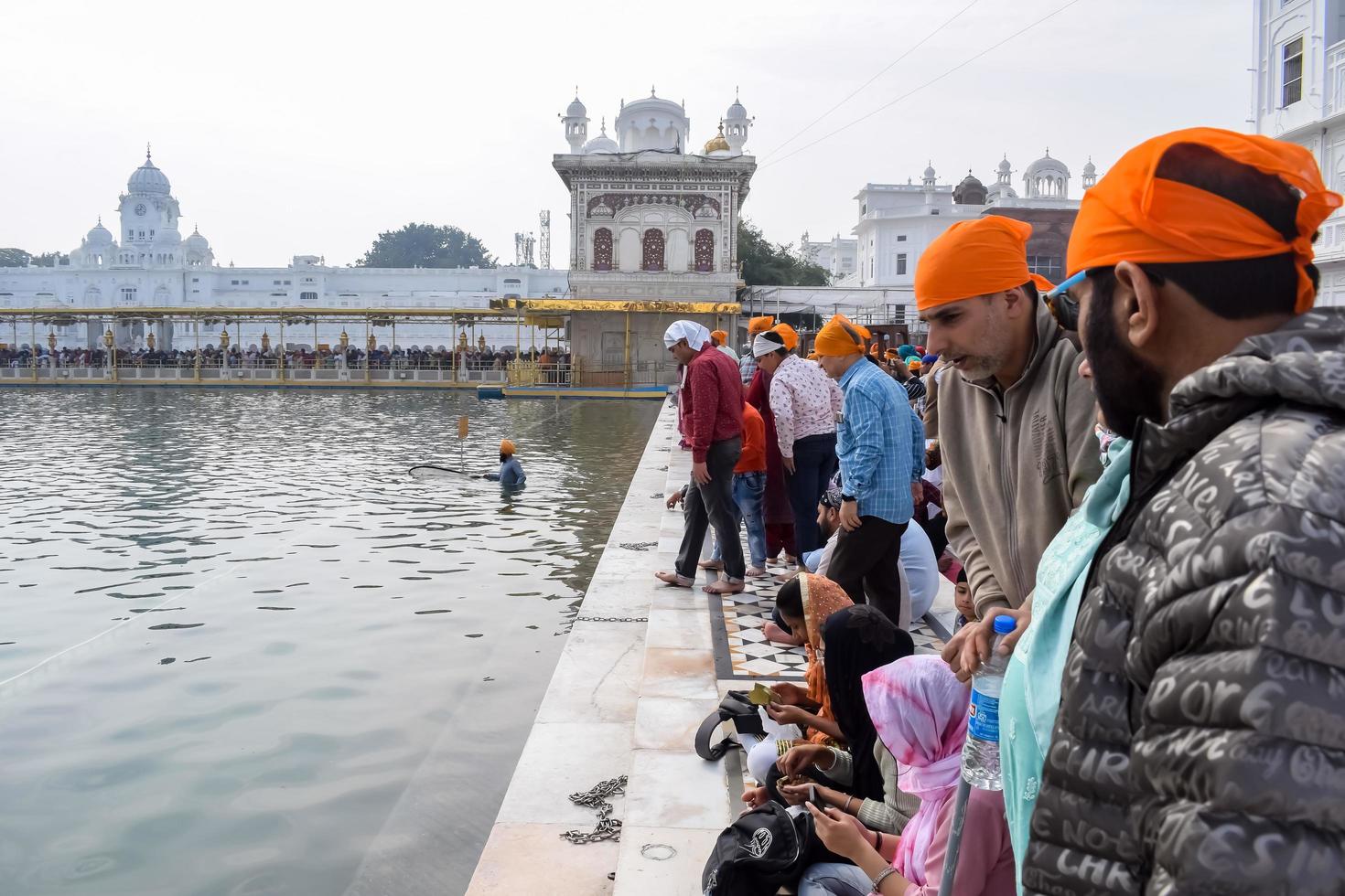 Amritsar, India - February 26 2023 - Unidentified devotees from various parts at Golden Temple - Harmandir Sahib in Amritsar, Punjab, India, Famous indian sikh landmark, Golden Temple photo