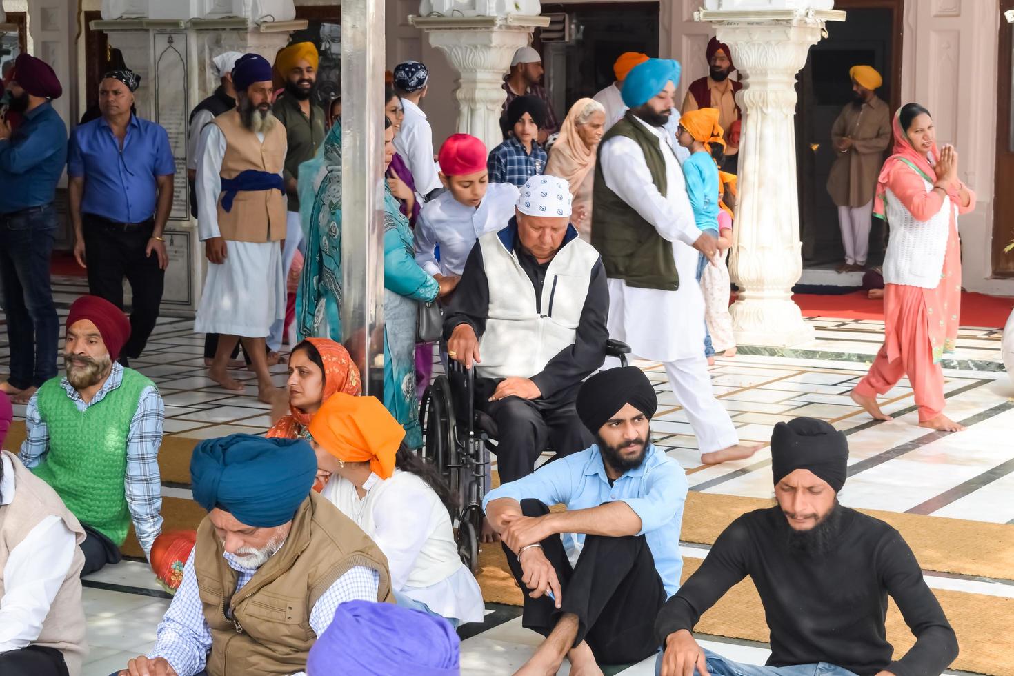 Amritsar, India - February 26 2023 - Unidentified devotees from various parts at Golden Temple - Harmandir Sahib in Amritsar, Punjab, India, Famous indian sikh landmark, Golden Temple photo
