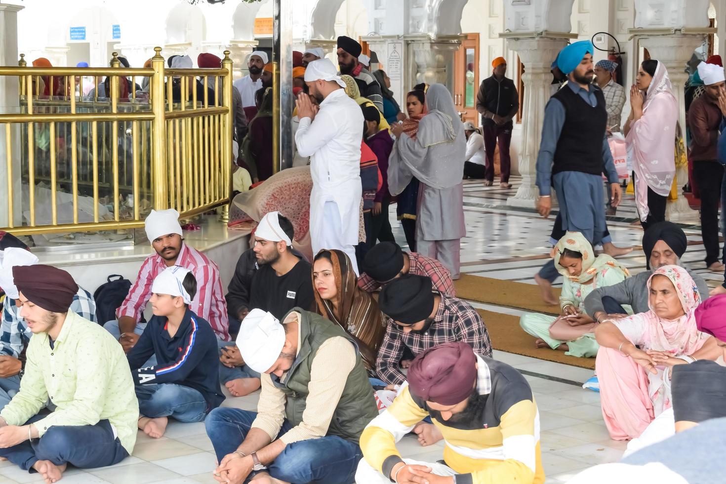 Amritsar, India - February 26 2023 - Unidentified devotees from various parts at Golden Temple - Harmandir Sahib in Amritsar, Punjab, India, Famous indian sikh landmark, Golden Temple photo