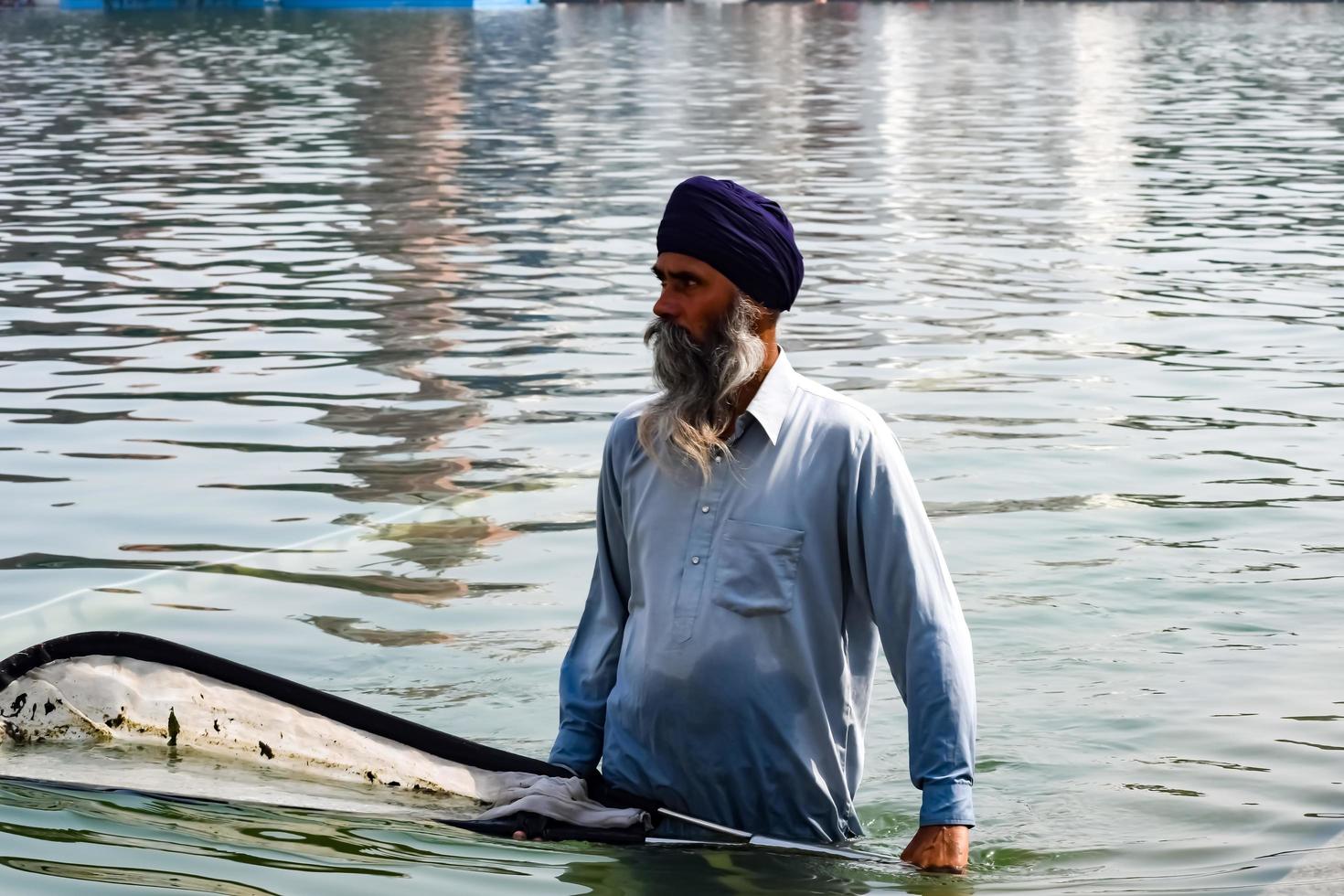 Amritsar, India - February 26 2023 - Unidentified devotees from various parts at Golden Temple - Harmandir Sahib in Amritsar, Punjab, India, Famous indian sikh landmark, Golden Temple photo