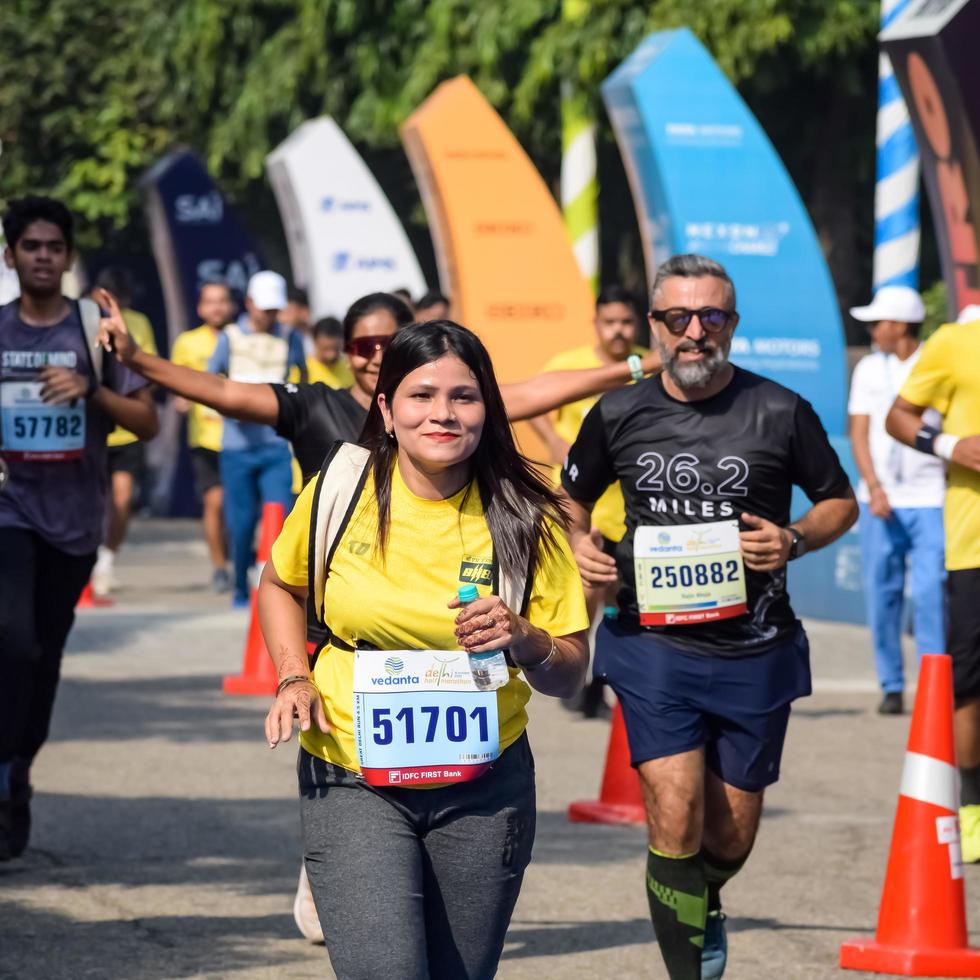 New Delhi, India - October 16 2022 - Vedanta Delhi Half Marathon race after covid in which marathon participants about to cross the finish line, Delhi Half Marathon 2022 photo