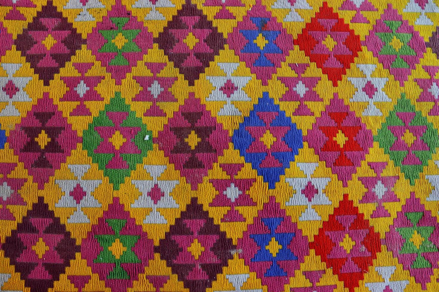 Bright square scheme of colored cross stitch,carpet texture.wallpaper ,background photo