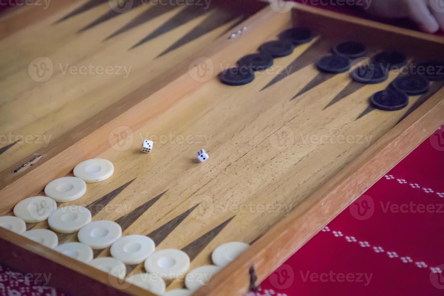 thrown dice on the table while playing backgammon photo