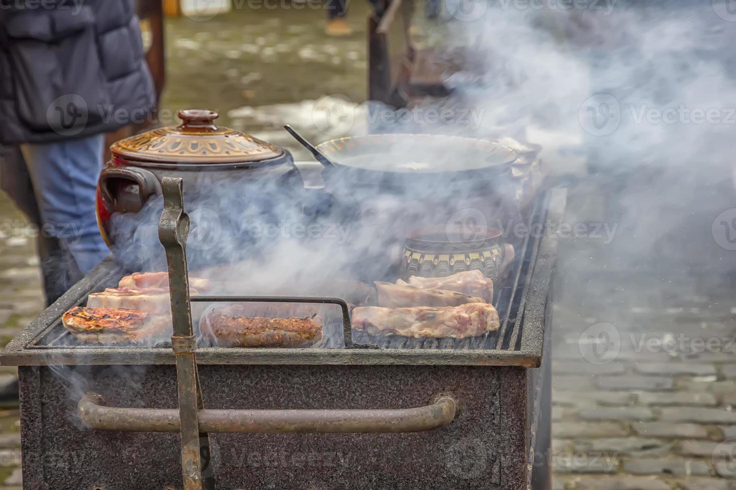 Street food and outdoor cooking concept. Grilled meat street food. photo