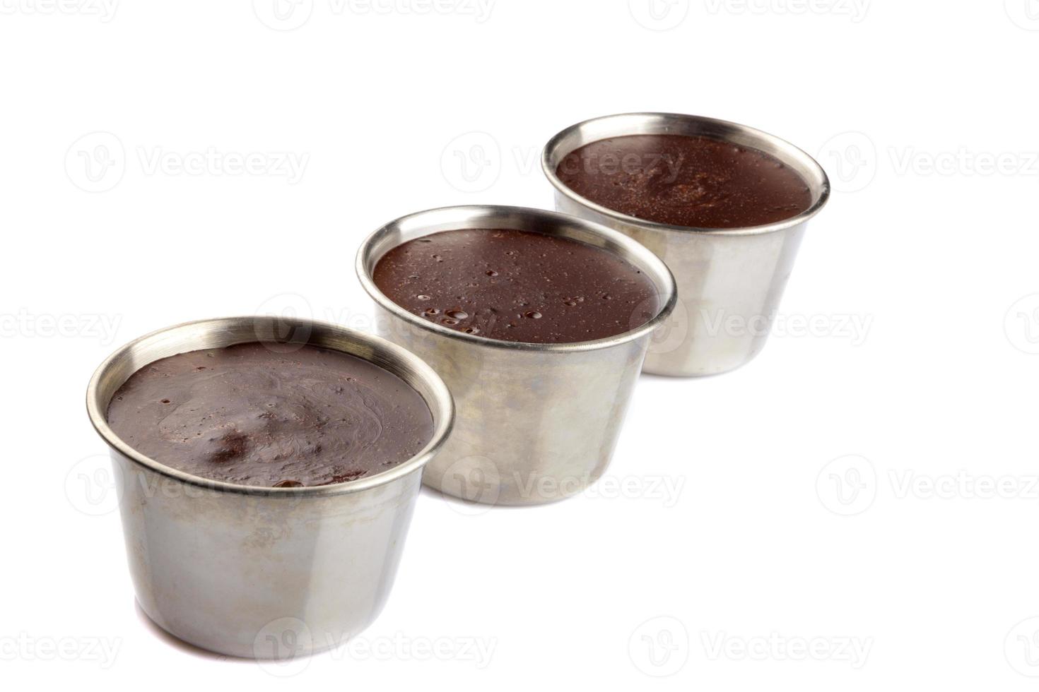 Homemade chocolate creme in a metal dessert bowl, isolated on white background. photo