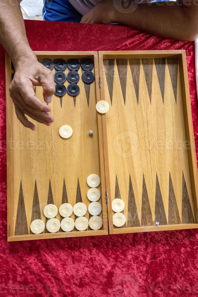 man throws dice while playing tabla photo