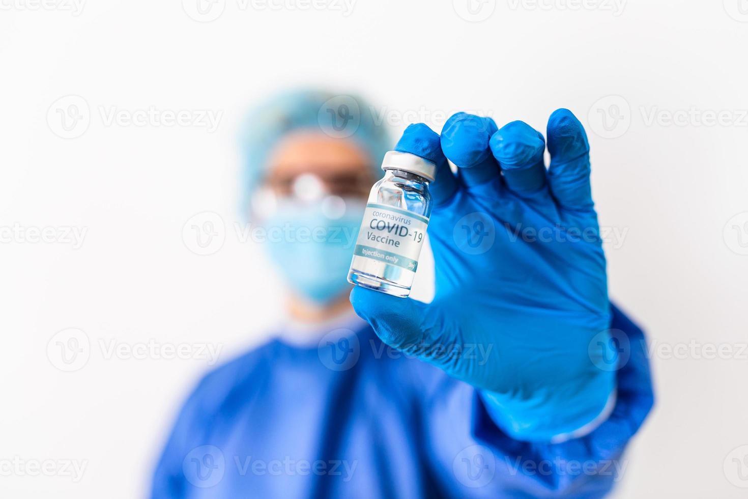 Female doctor holding COVID-19 vaccine. Healthcare And Medical concept.Vaccine vial dose flu shot drug needle syringe,medical concept vaccination hypodermic injection treatment photo