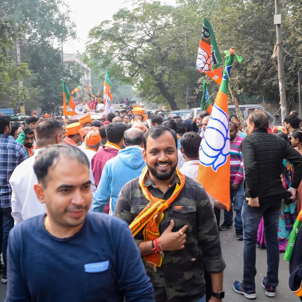 Delhi, India, December 02 2022 -Bharatiya Janata Party - BJP supporter during mega road show in support of BJP candidate Pankaj Luthara to file nomination papers ahead of MCD local body Elections 2022 photo