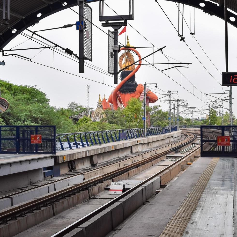 New Delhi India - June 21 2022 - Delhi Metro train arriving at Jhandewalan metro station in New Delhi, India, Asia, Public Metro departing from Jhandewalan station photo