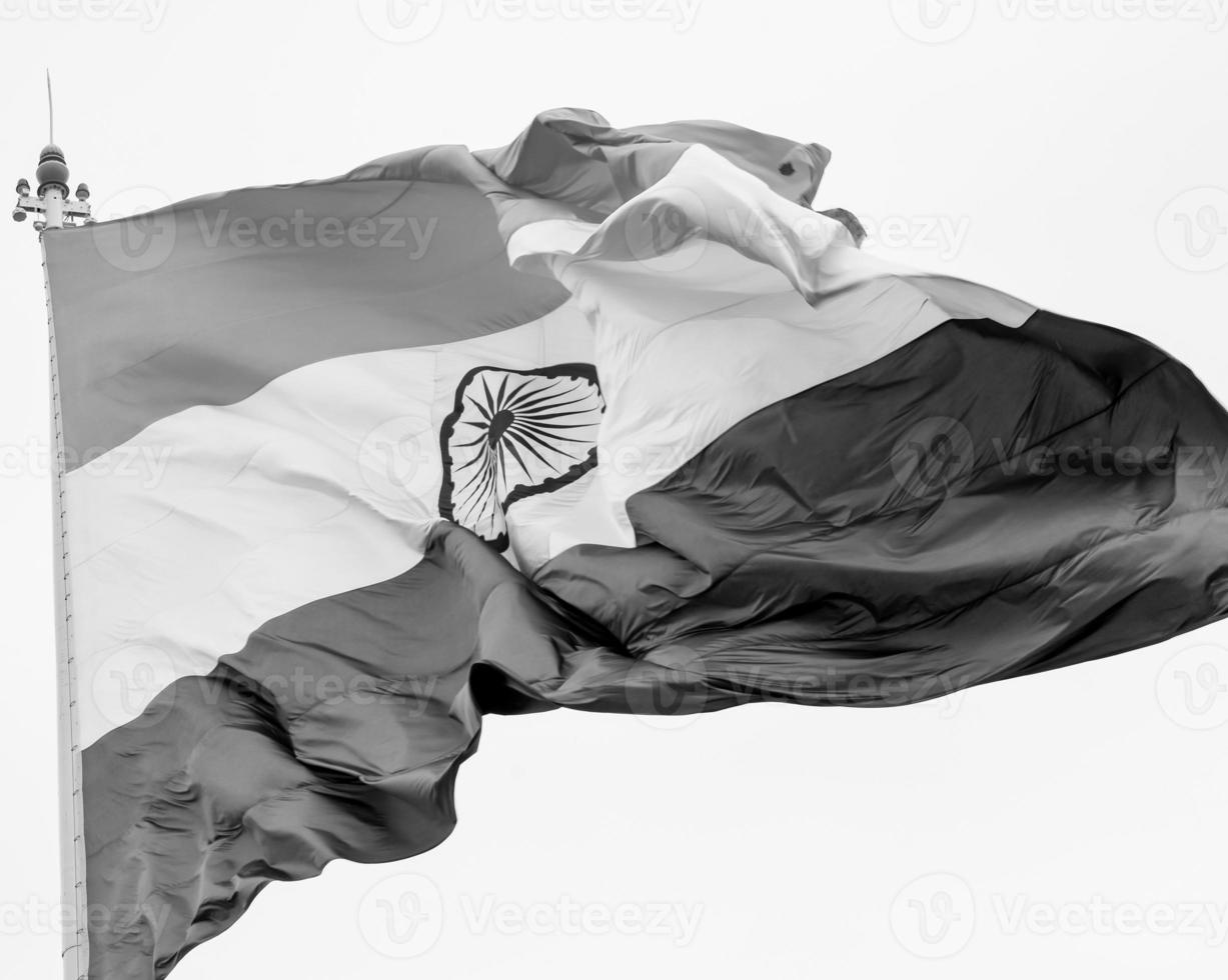 India flag flying high at Connaught Place with pride in blue sky, India flag fluttering, Indian Flag on Independence Day and Republic Day of India, tilt up shot, Waving Indian flag, Har Ghar Tiranga photo