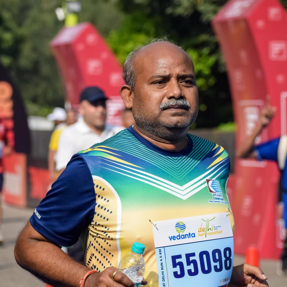New Delhi, India - October 16 2022 - Vedanta Delhi Half Marathon race after covid in which marathon participants about to cross the finish line, Delhi Half Marathon 2022 photo