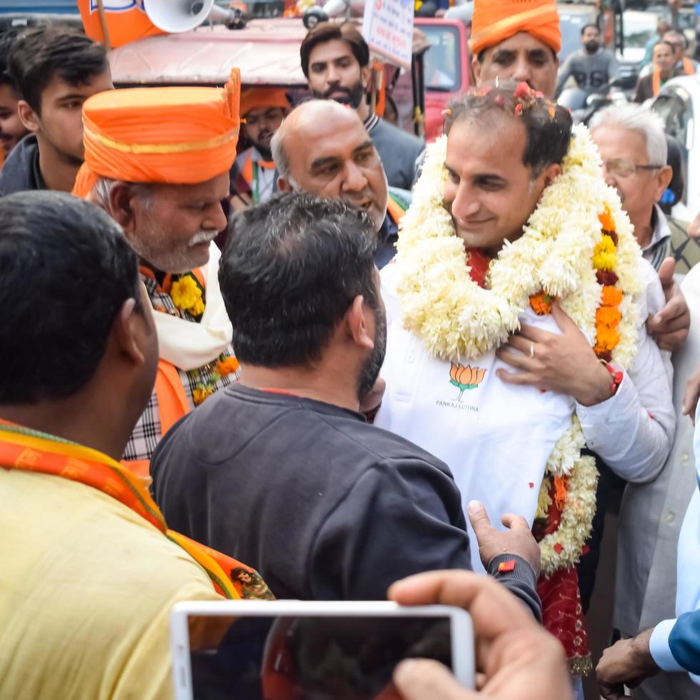 Delhi, India, December 02 2022 -Bharatiya Janata Party BJP supporter during mega road show in support of BJP candidate Pankaj Luthara to file nomination papers ahead of MCD local body Elections 2022 photo