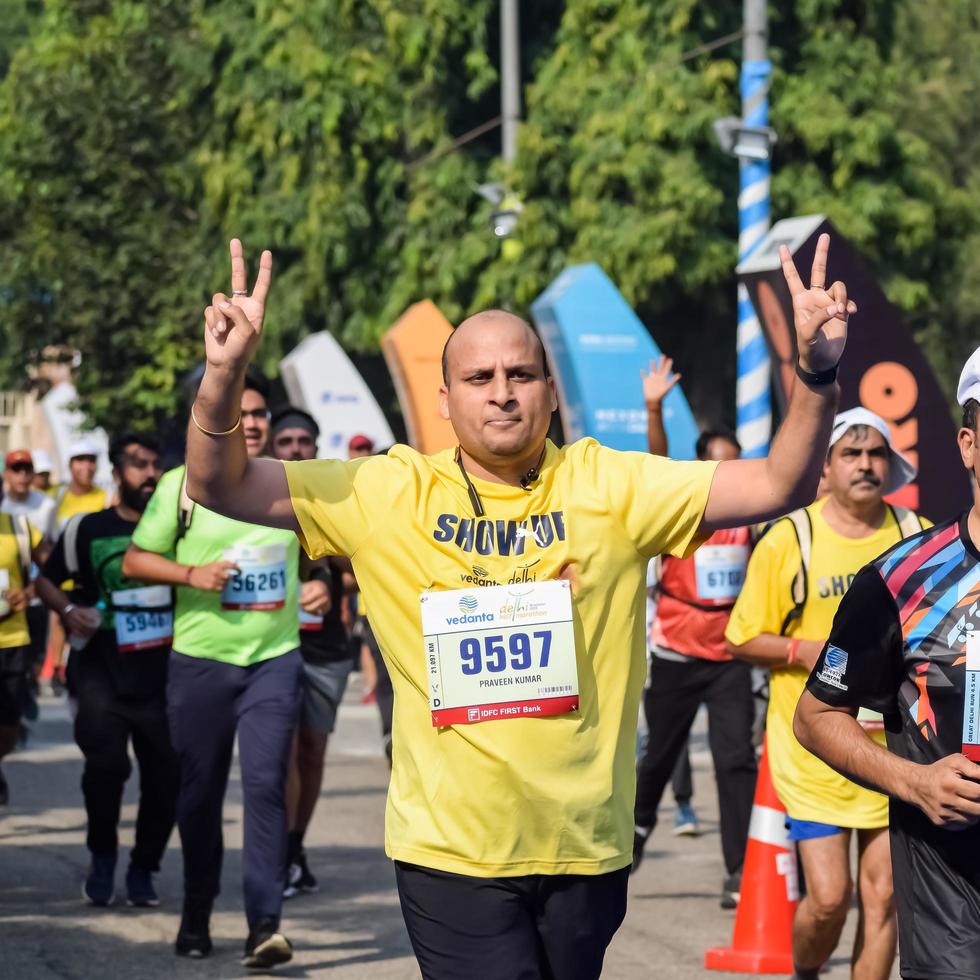 New Delhi, India - October 16 2022 - Vedanta Delhi Half Marathon race after covid in which marathon participants about to cross the finish line, Delhi Half Marathon 2022 photo