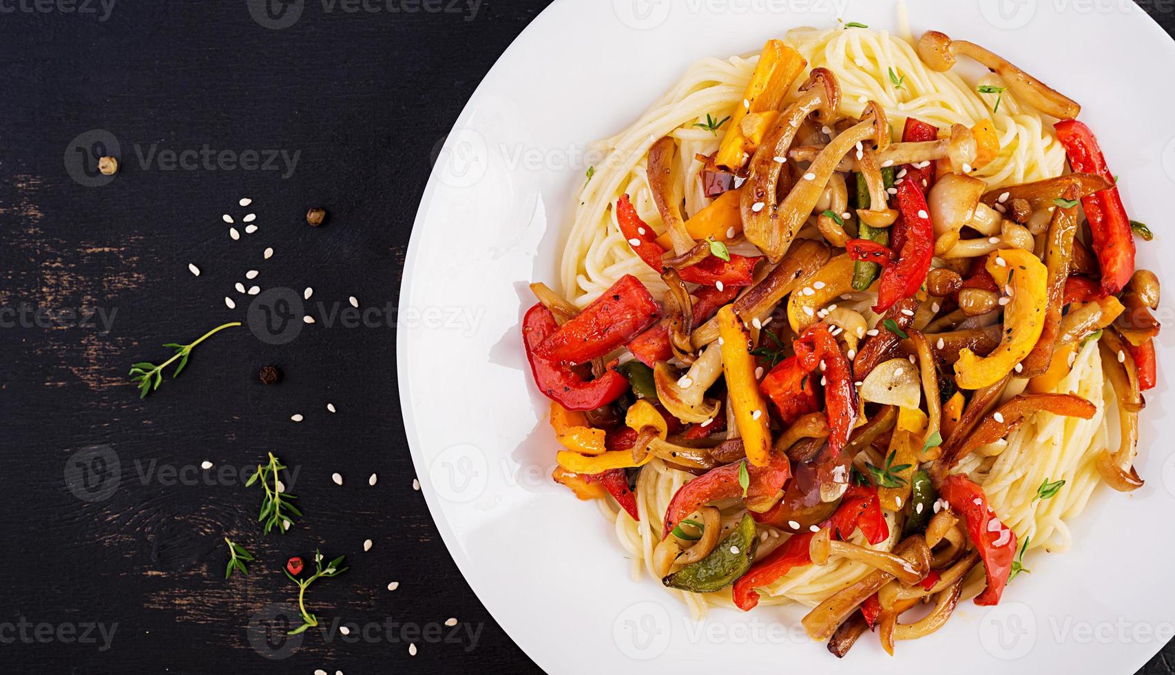 Noodles with shimeji mushrooms and paprika. Oriental meal. Japanese Shimeji mushroom stir fry. Top view photo