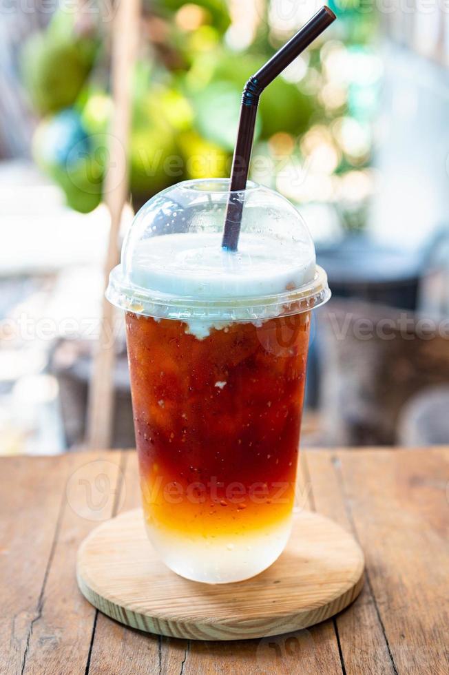 Coffee drip with coconut milk cream closeup photo