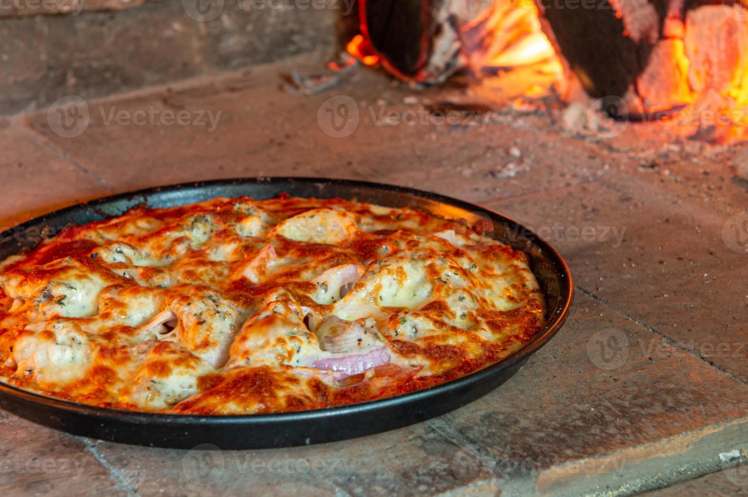 Closeup of pizza in the wood fire oven photo