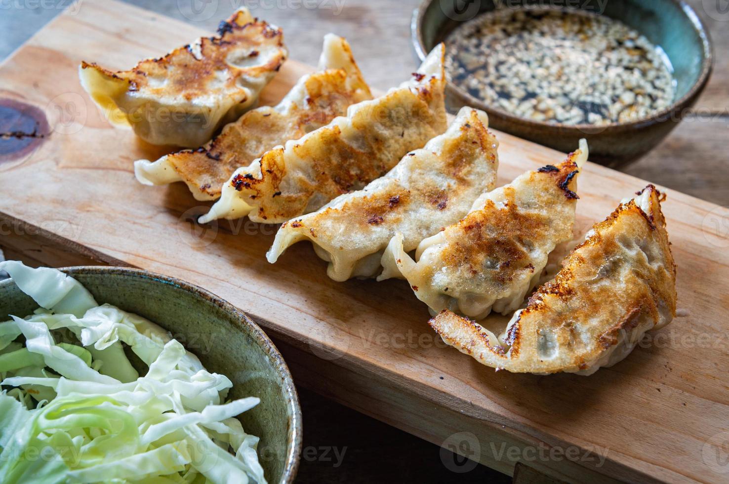 Gyoza on chopping block Japanese food style photo