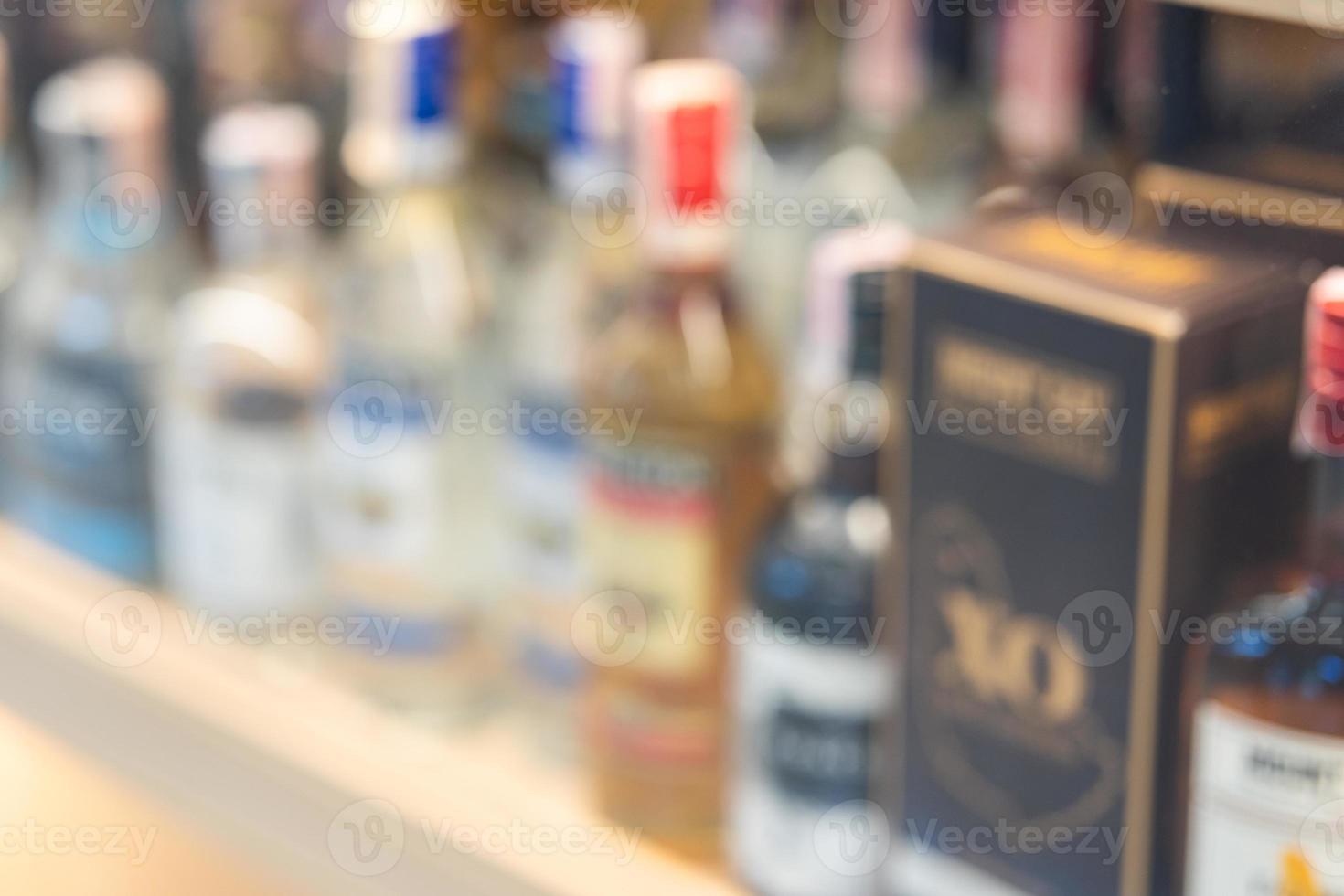 Blurred of wine bottles or different bottles of alcohol. row of alcoholic bottles. photo