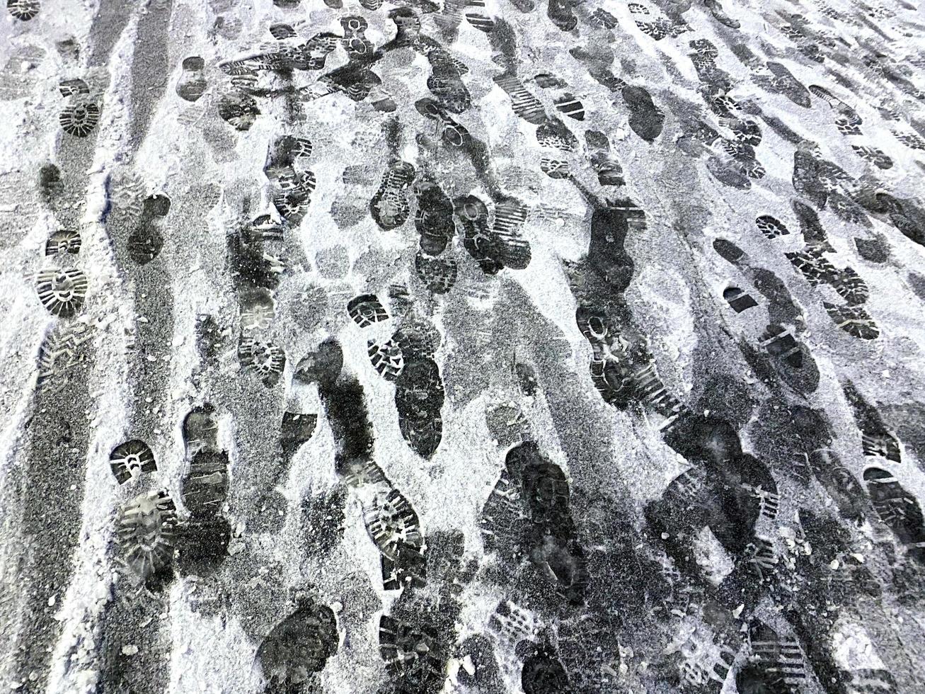 Footprints of people in the snow. photo