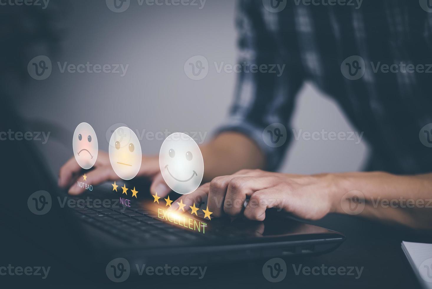 Businessman using laptop computer to input point and evaluation result on company website, Customer service satisfaction survey, satisfaction through the application on tablet screen, rating 5 stars. photo
