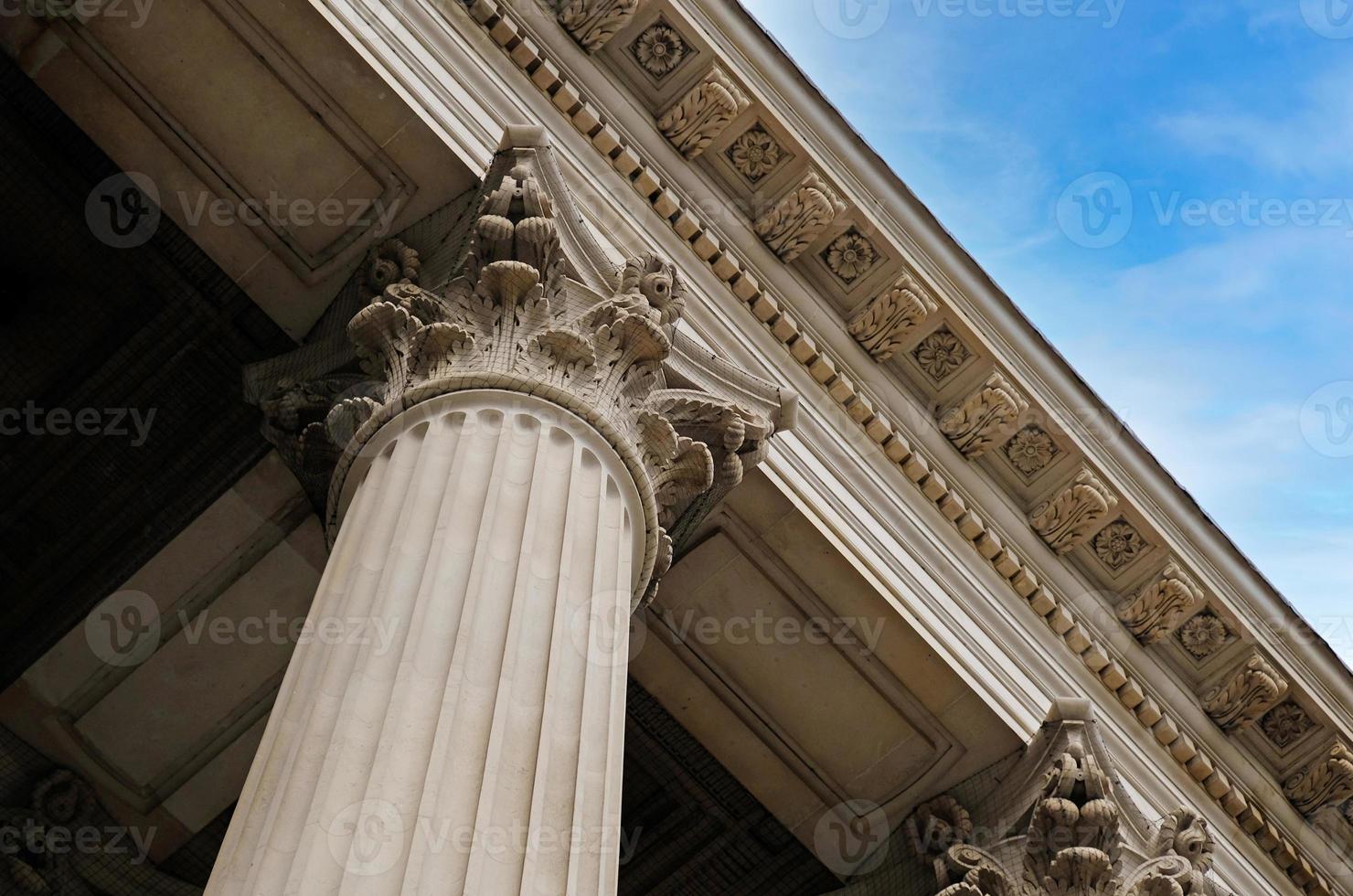 Classic architectural column. Details of architecture of historical construction. Element of exterior building with columns and Stucco molding on ceiling of architectural structure in London, UK. photo