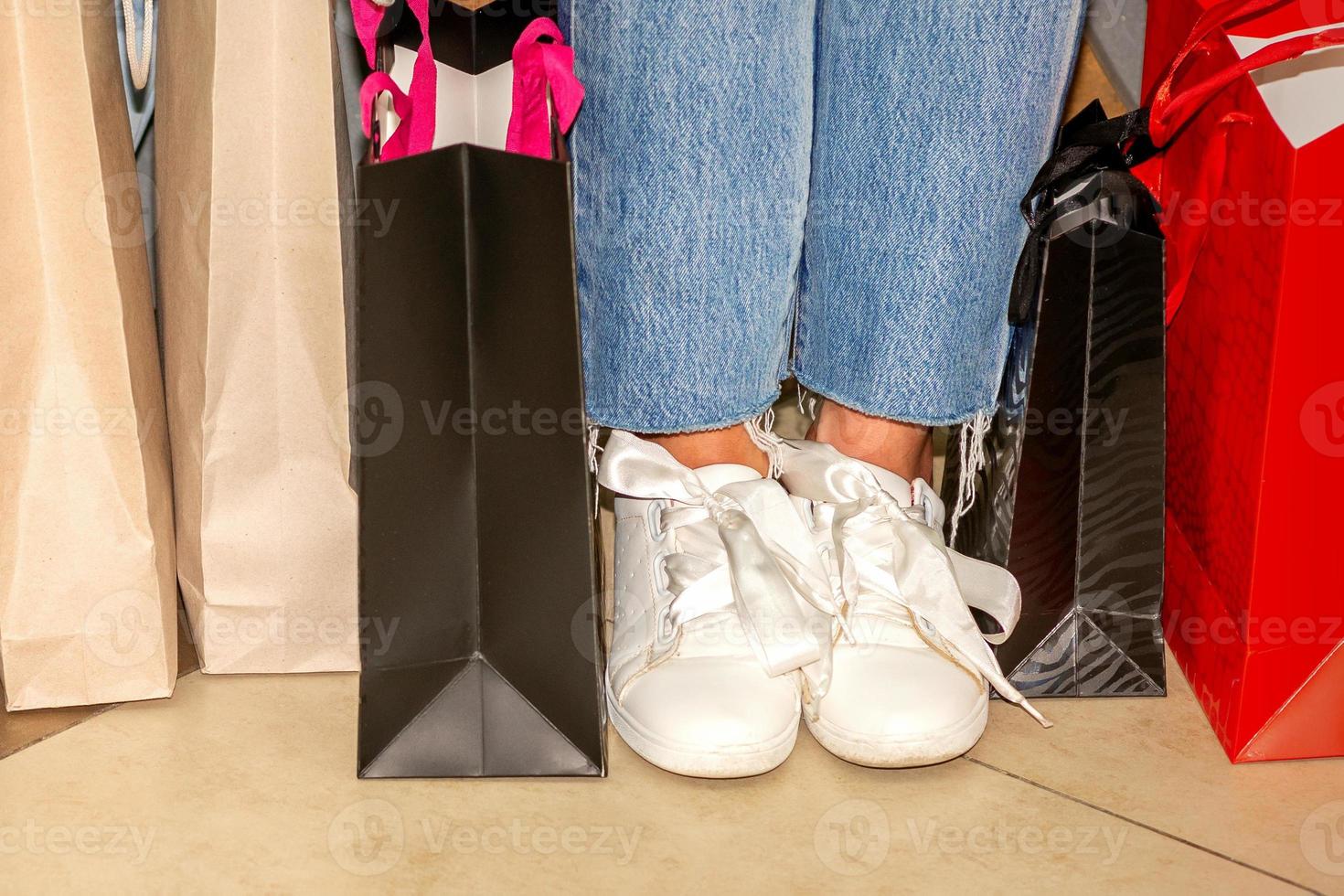 Legs of woman with shopping bags photo