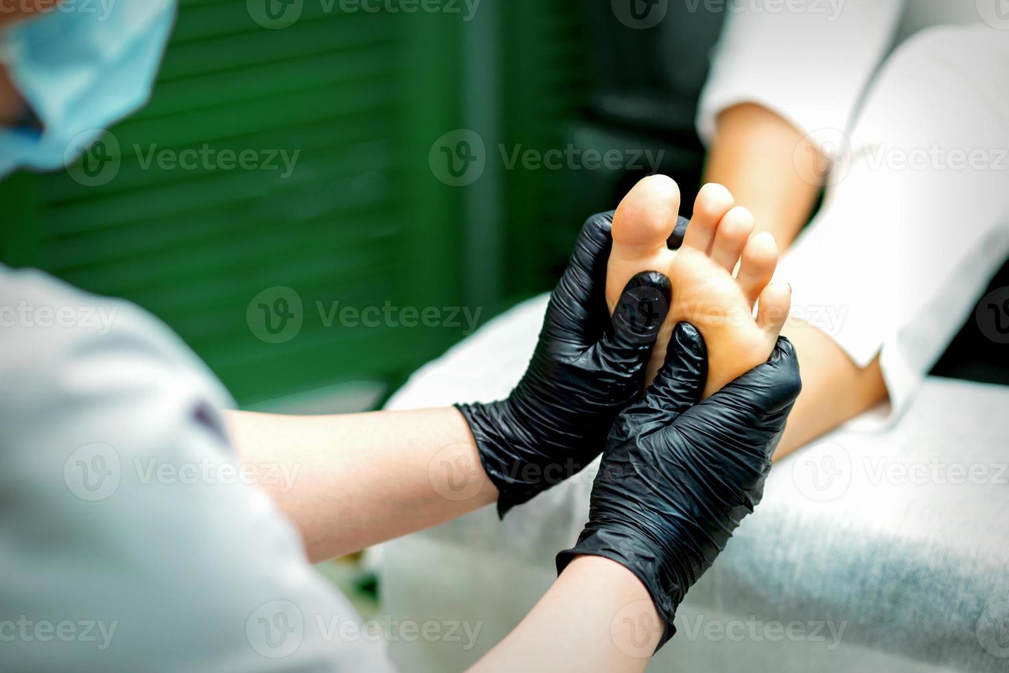 Beautician doing massage on the sole photo