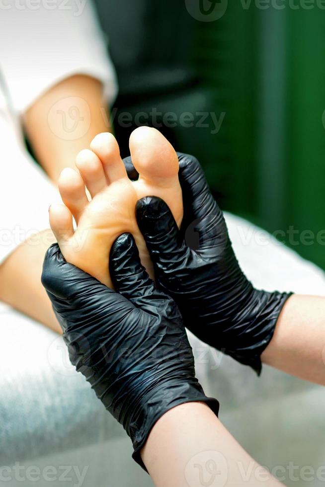 Beautician doing massage on the sole photo