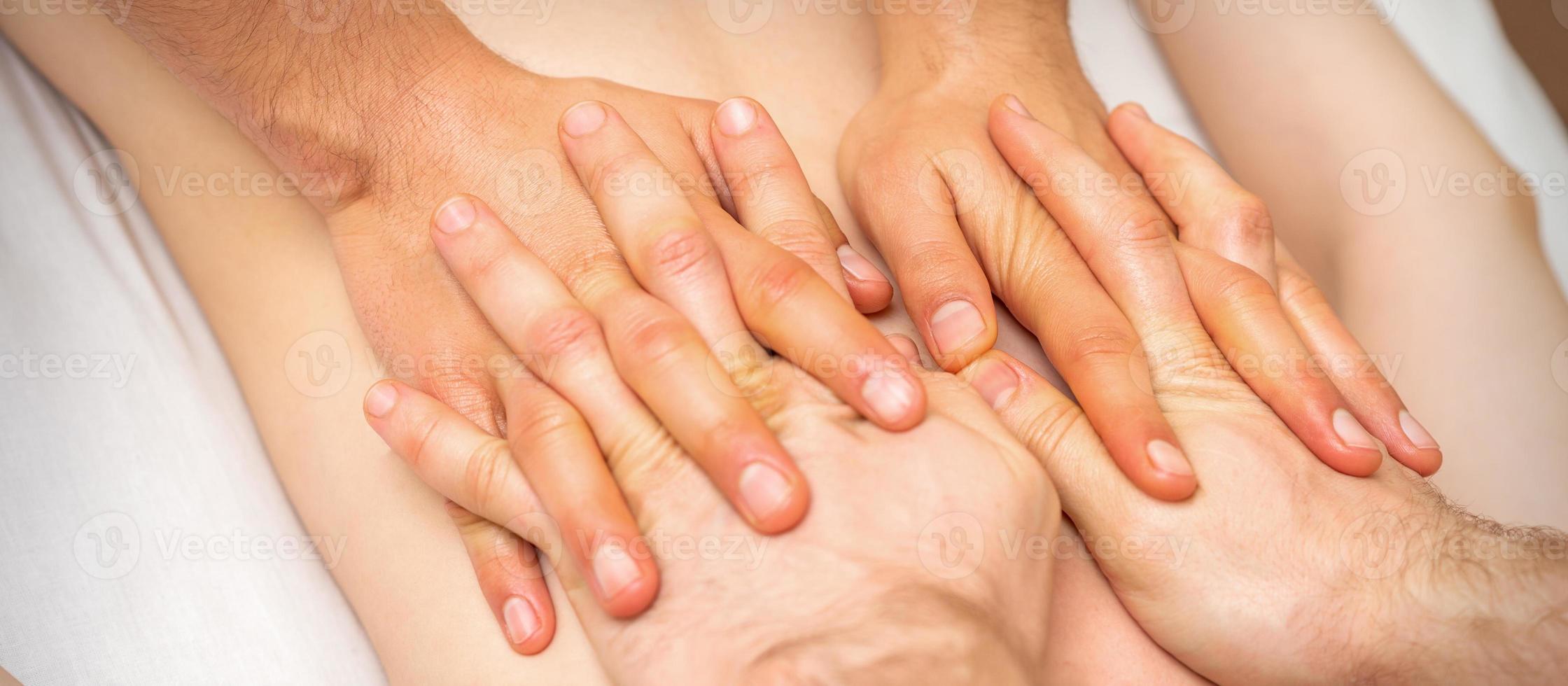 4 hands massage the patient back photo