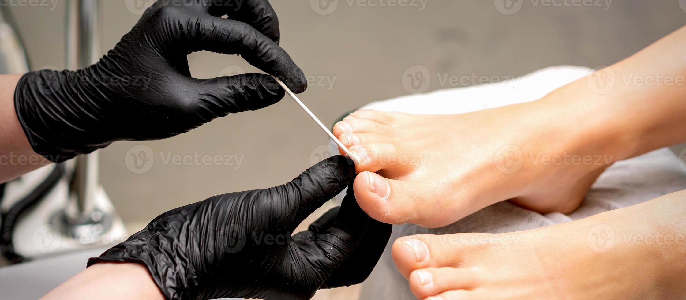 File toenails with nail file photo