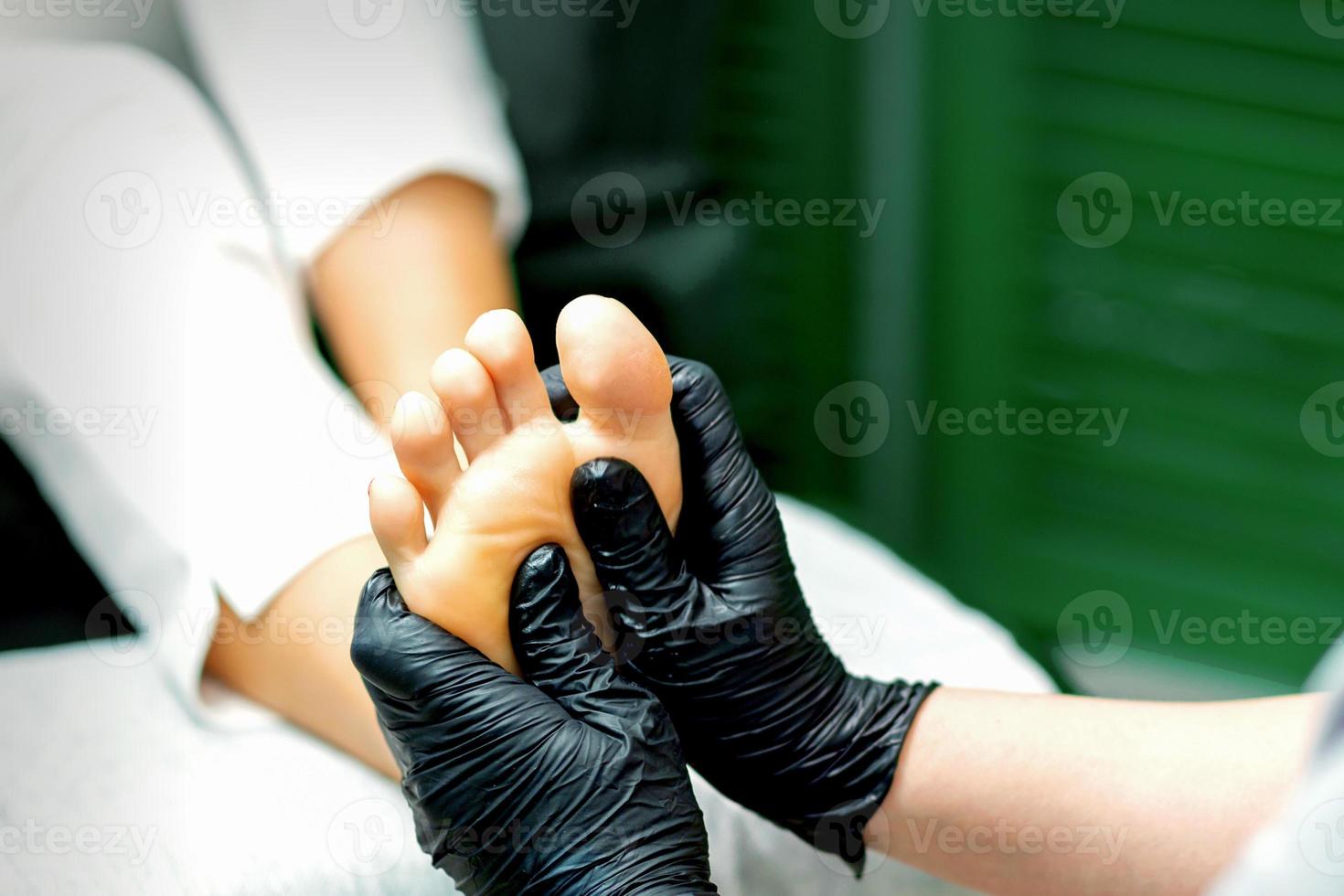 Young woman receiving foot massage photo