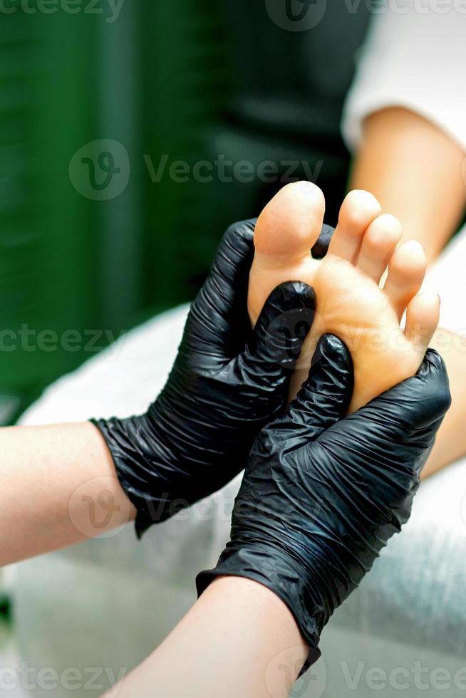 Young woman receiving foot massage photo