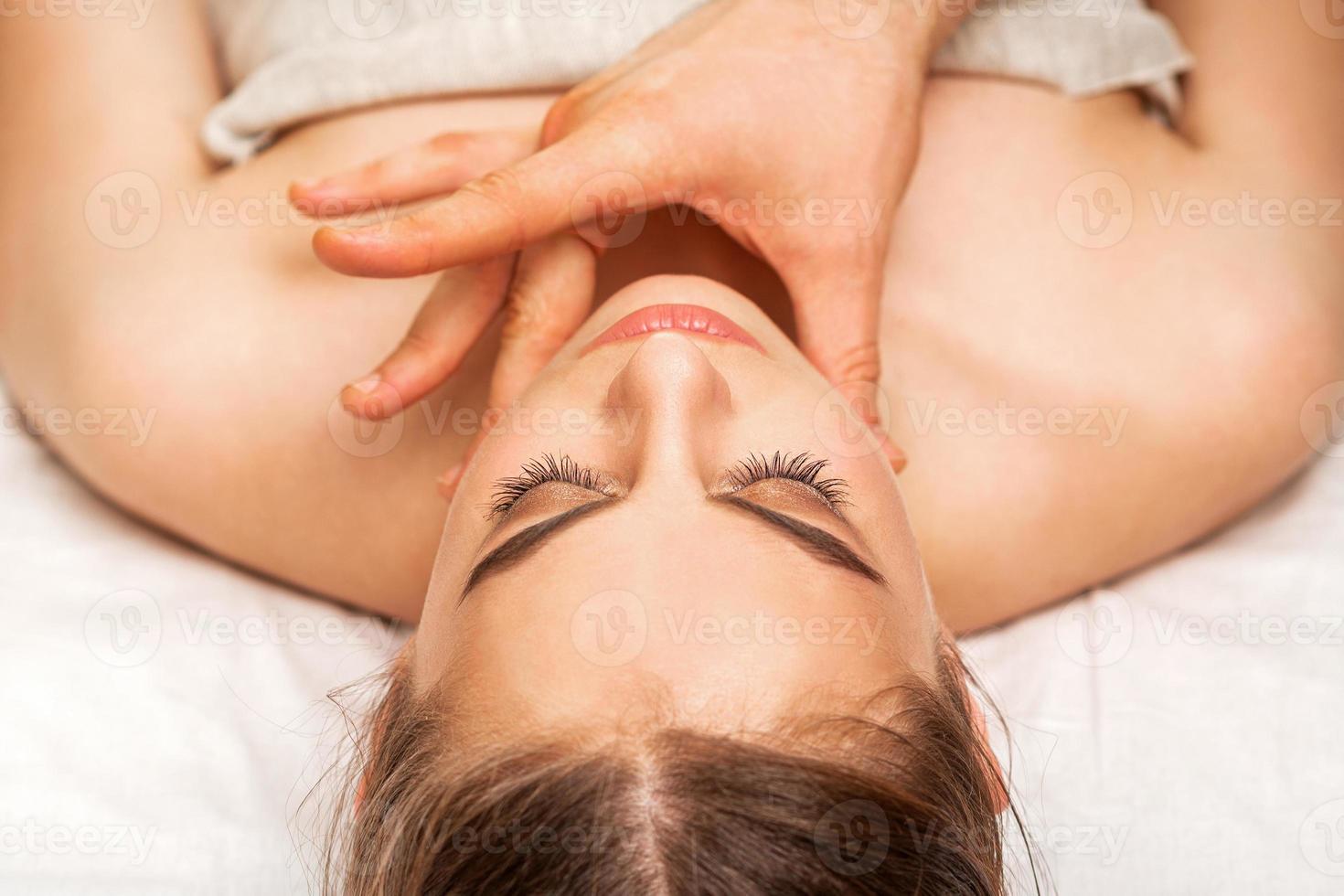 Chin or neck massage of woman photo