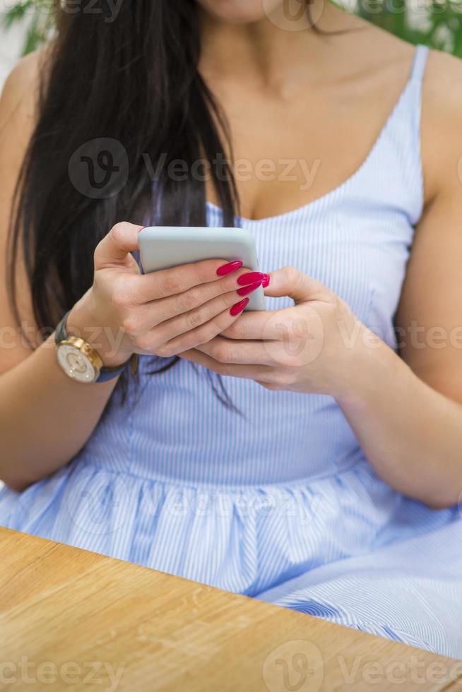 Young woman uses a smartphone photo